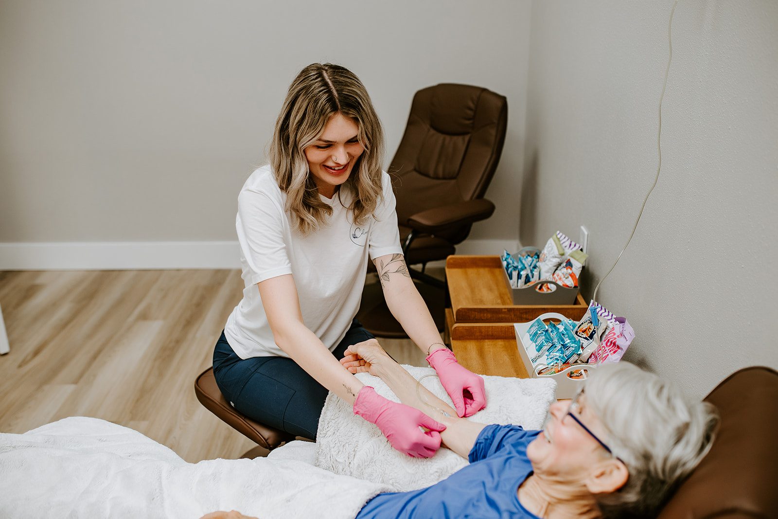 A client resting in a recliner while receiving an IV vitamin drip at Silique IV Hydration in Lake City, FL